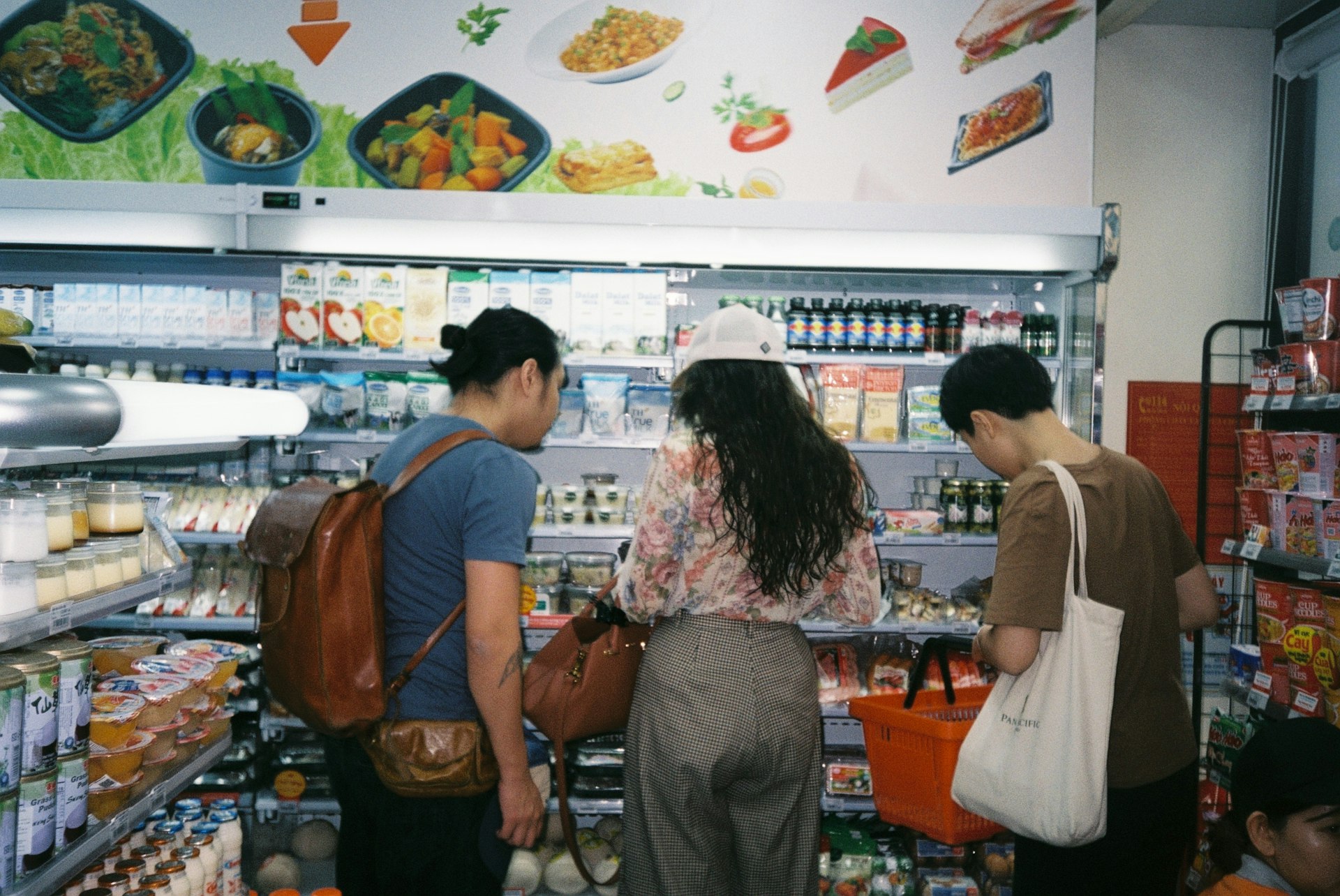 woman in brown long sleeve shirt and gray pants standing in front of white counter